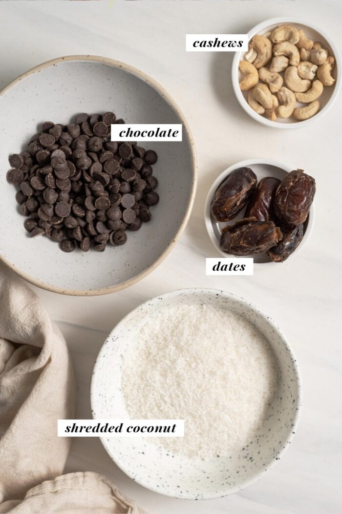 Coconut, cashews, dates and chocolates in bowls, labelled with Coconut, cashews, dates and chocolates in bowls, labelled with text overlay. overlay.