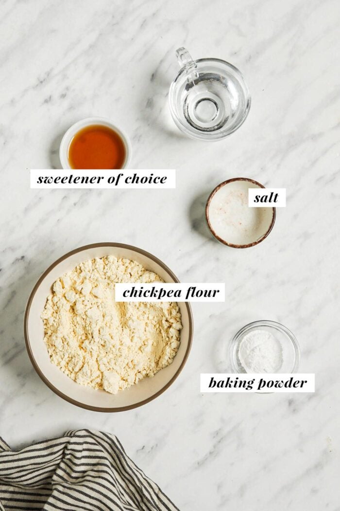 Visual list of ingredients for making a vegan chickpea flour pancake recipe. Each ingredient is labelled with text describing the ingredient.